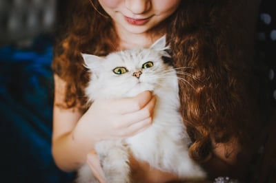 Girl holding a white cat