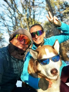 Owners taking a selfie with Husky in sunglasses