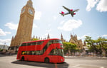 Picture of London with Big Ben in the background and a plane overhead.