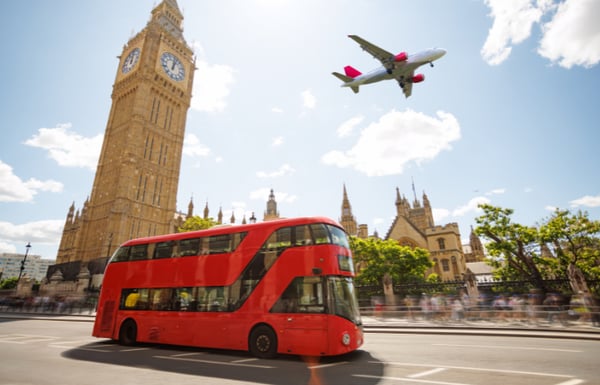 Picture of London with Big Ben in the background and a plane overhead.