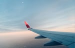 View looking out of an airplane at the wing of the plane.