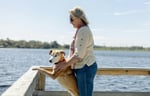 Dog and owner looking over a body of water in Australia.