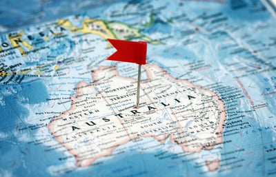 Australia on a map with a red flag pinned in the middle.