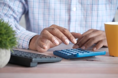 Hands using calculator
