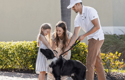 Mom and daughter saying goodbye to dog before releasing to Starwood representative for pet travel.
