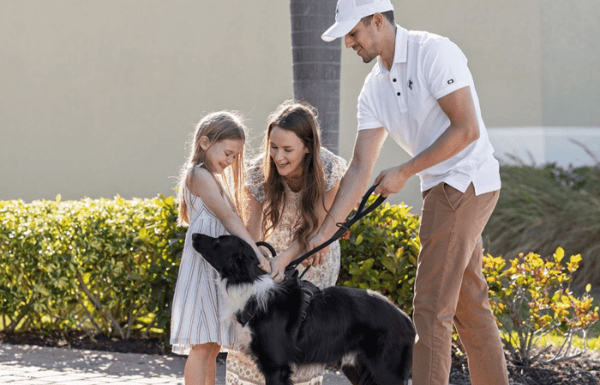 Mom and daughter saying goodbye to dog before releasing to Starwood representative for pet travel.