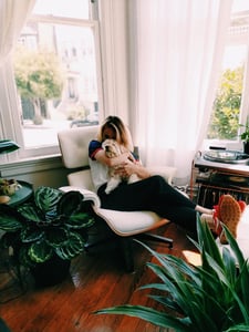 woman hugging dog in an apartment