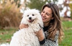 Woman playing outside with her dog.